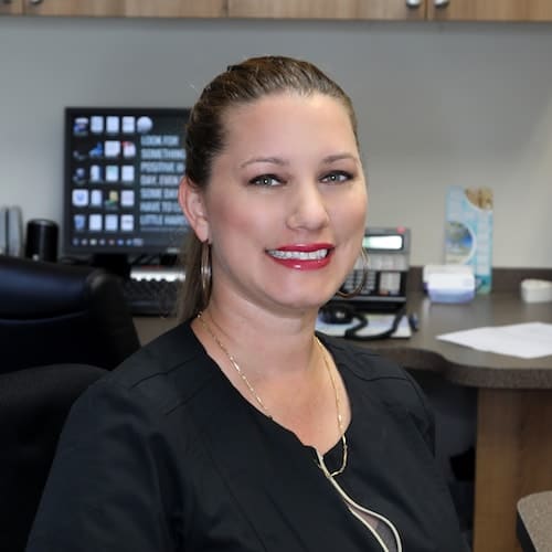 Welcome to one of top dentists in Palm Beach Gardens A staff member greeting people with a smile at one of the top dentists in Palm Beach Gardens