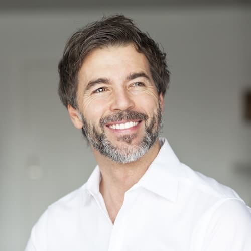Restorative Dentistry Palm Beach Gardens - Dental Bridges Man smiling after getting bridges and Restorative Dentistry Palm Beach Gardens