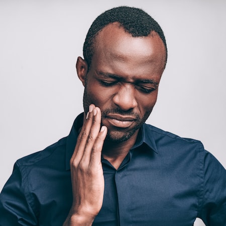 Your dentist in Palm Beach Gardens FL fixes broken or cracked teeth A man with a cracked tooth and who is going to visit his dentist in Palm Beach Gardens FL
