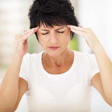 Your dentist in Palm Beach Gardens FL provides TMJ care A woman suffering from TMJ, a service provided by your dentist in Palm Beach Gardens FL