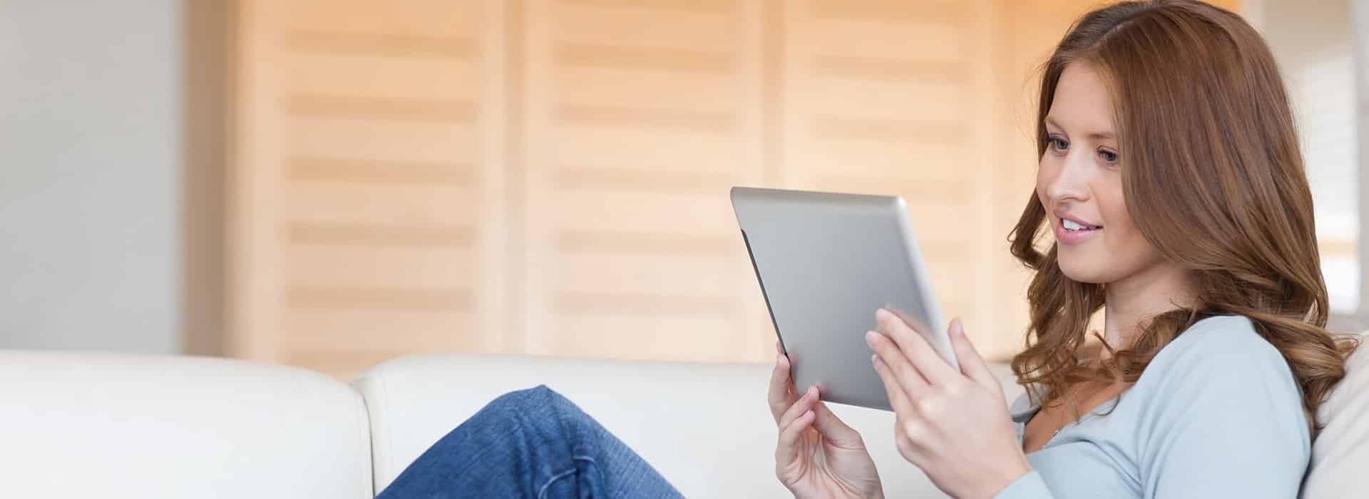 Dentist in Palm Beach Gardens FL - Woman on Ipad Woman on her iPad learning more about your dentist in Palm Beach Gardens FL