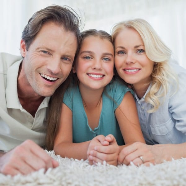 Happy couple with their daughter smiling