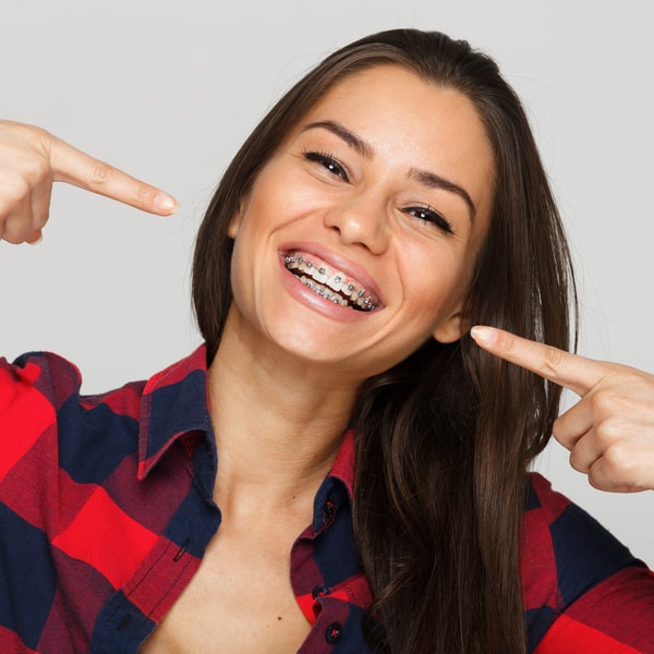 Woman happily smiling and showing off her braces