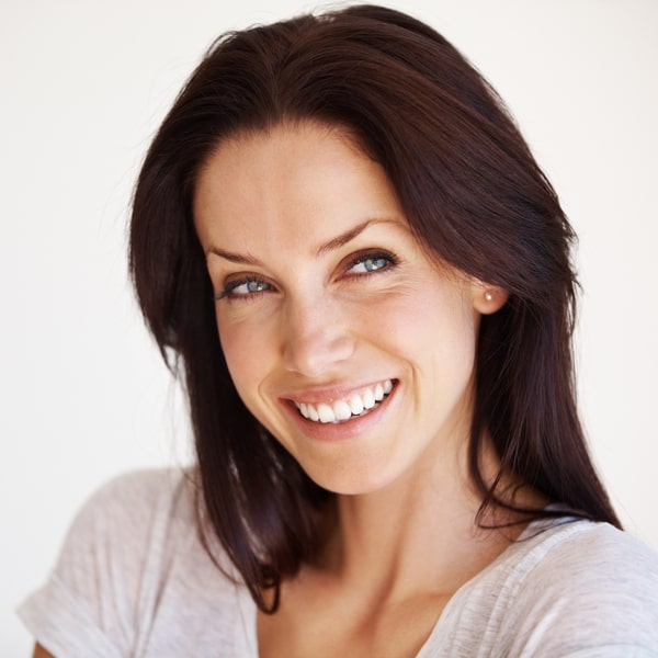 Woman with dark hair is happily smiling
